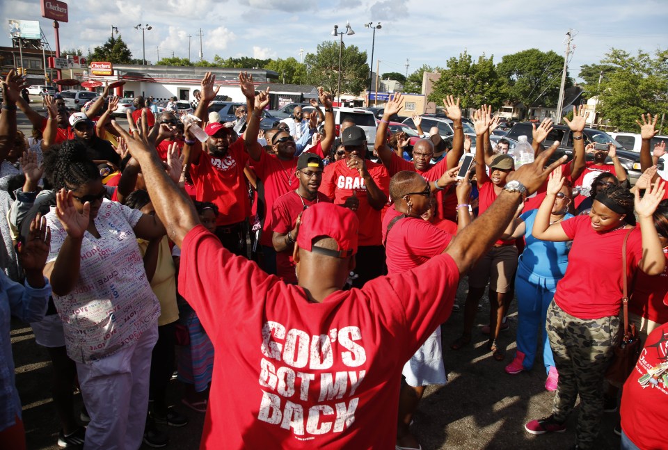  Large groups gathered to encourage peace after the fatal shooting