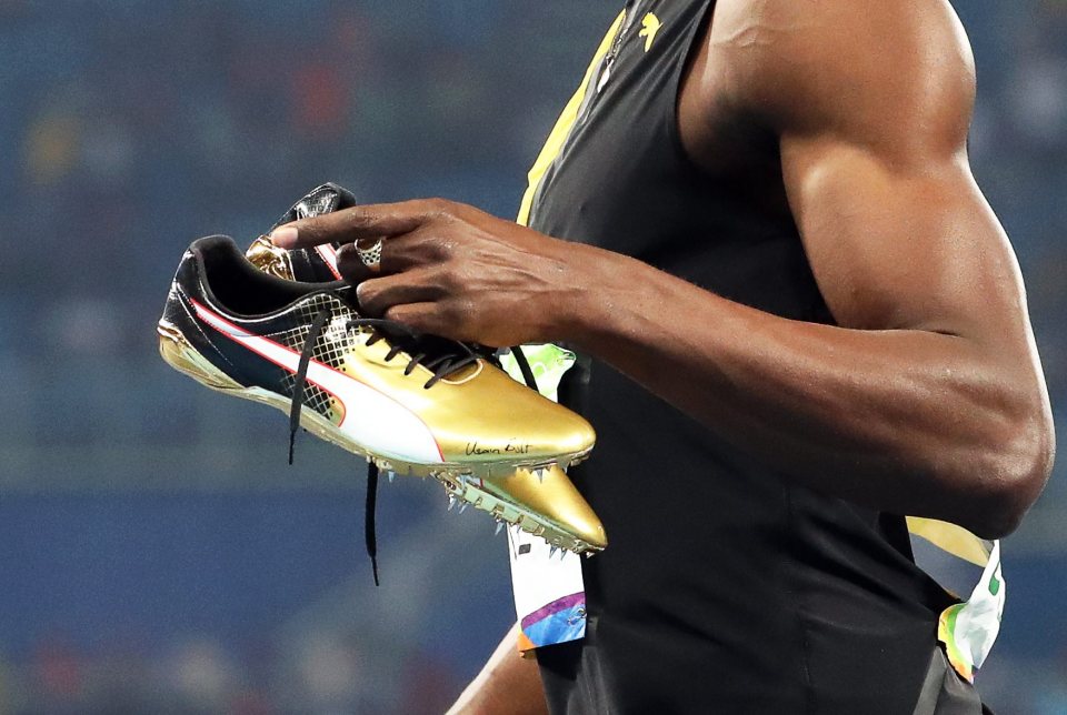  Usain Bolt wore his trademark golden spikes during the men's 100 metres final