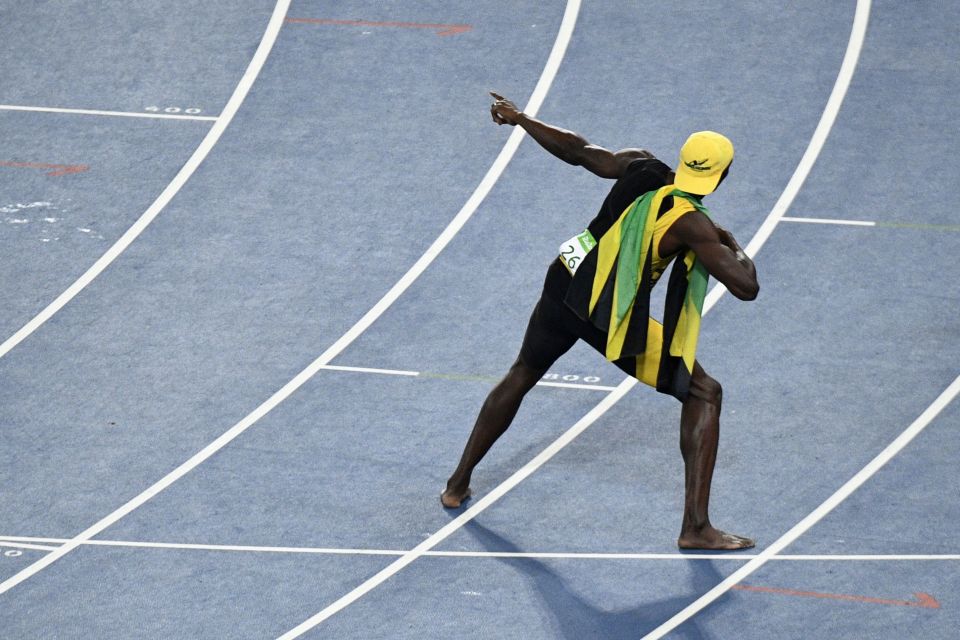  Usain Bolt pulls his trademark pose after winning his third Olympic 100m title