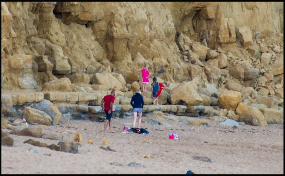  Families were enjoying the sunshine on the beach while the boys through stones down