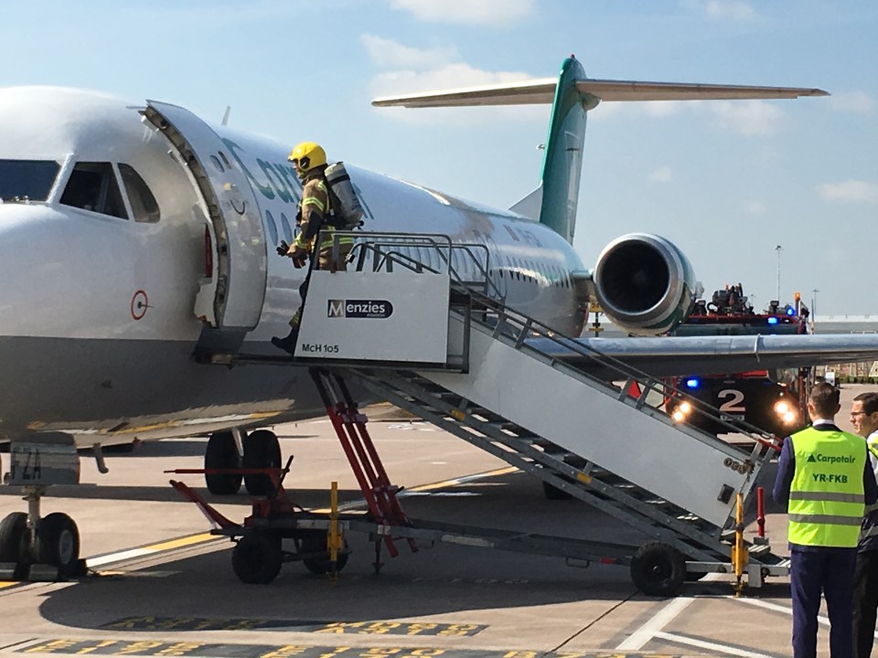  An emergency services worker boards the evacuated Man City plane