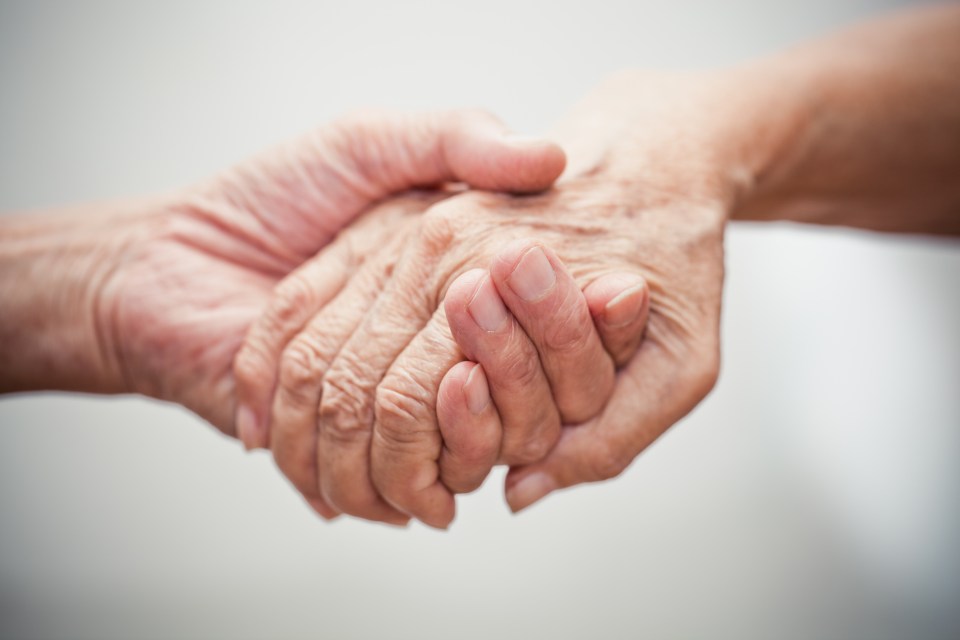 One person lending a hand to a elderly person