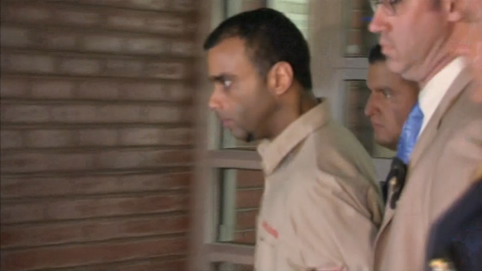  Morel is walked out by New York police after being charged with the murder of two men out the front of a Queens mosque