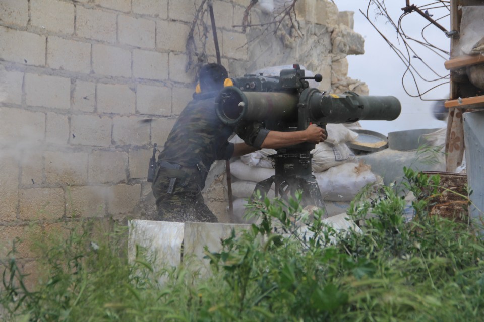  Fighters from the Free Syrian Army fire rockets at the regimes positions during the clashes