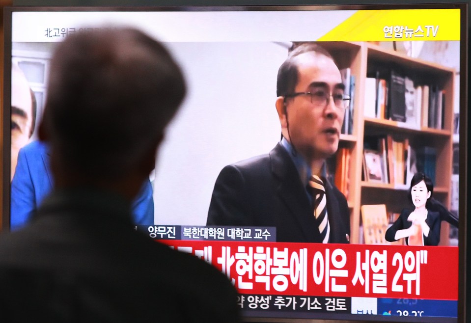 A man watches a TV news airing a file image of Thae Yong Ho, minister at the North Korean Embassy in London, at Seoul Railway Station in Seoul, South Korea