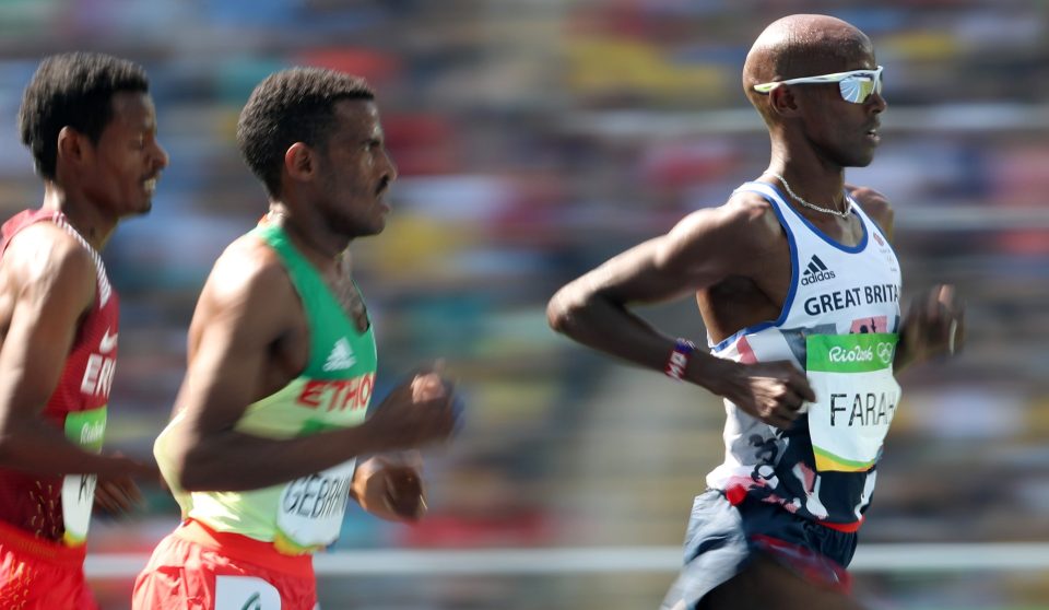 Britain's Mo Farah, right, competes in a men's 5000-meter heat