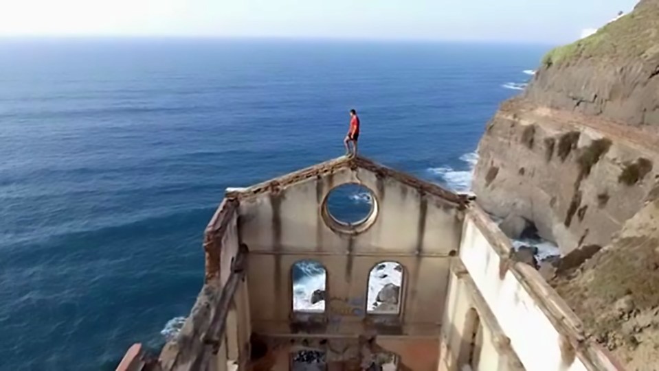 The heart-stopping image of Rubén Alonso Bizarro shows the thrill-seeker standing on top of the Spanish ruins