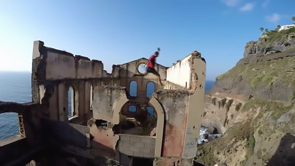 The daredevil can be seen to jump between the ageing walls of the seaside ruin