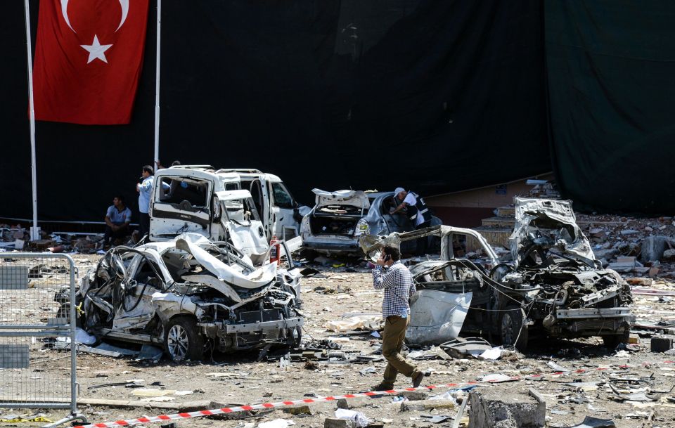 A man walks among the wreckage of vehicl