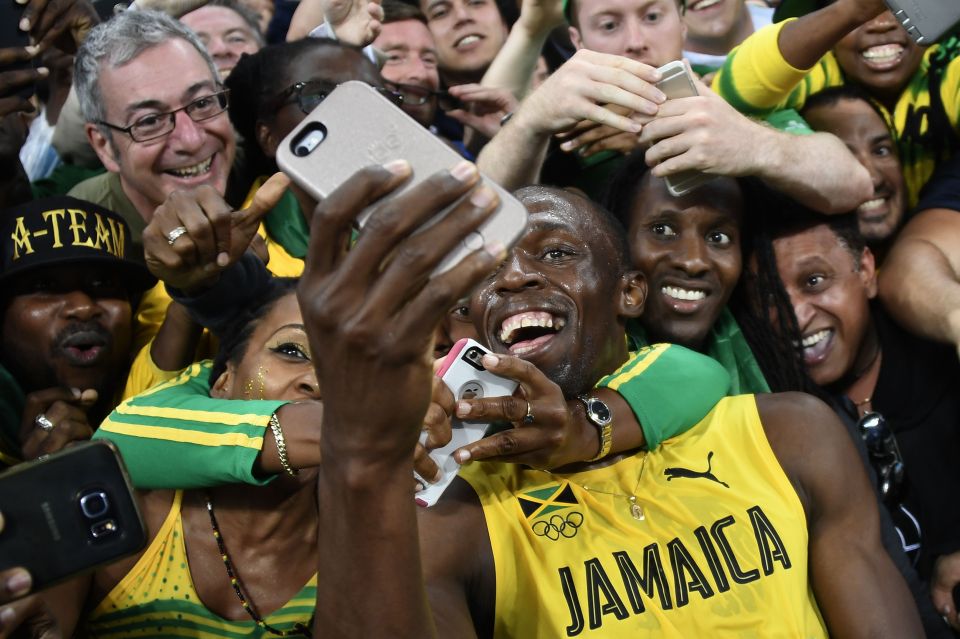  Usain Bolt takes selfie photos as he celebrates with fans