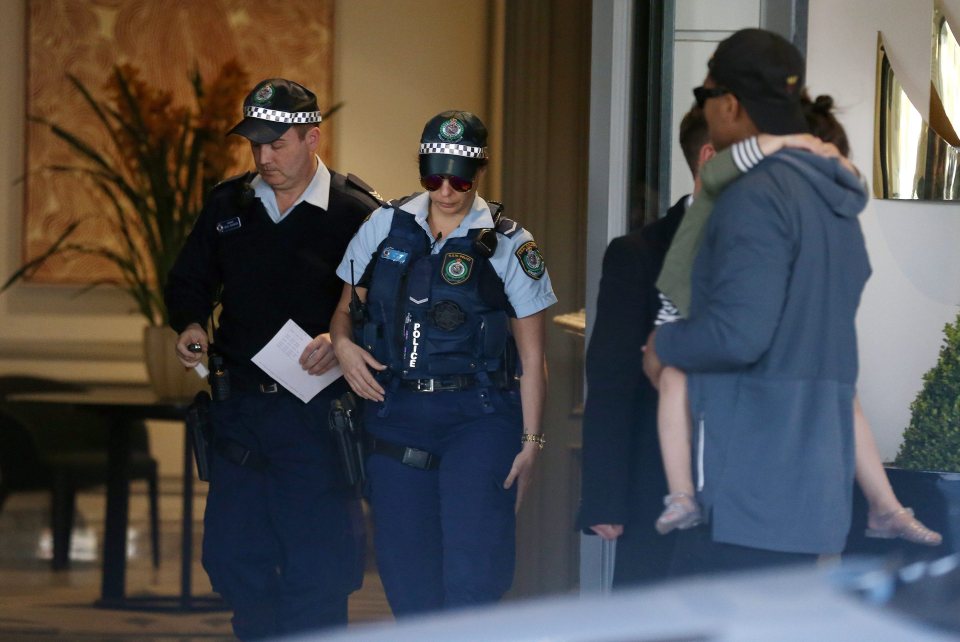  Police officers leave the hotel where the All Blacks have been staying in Sydney