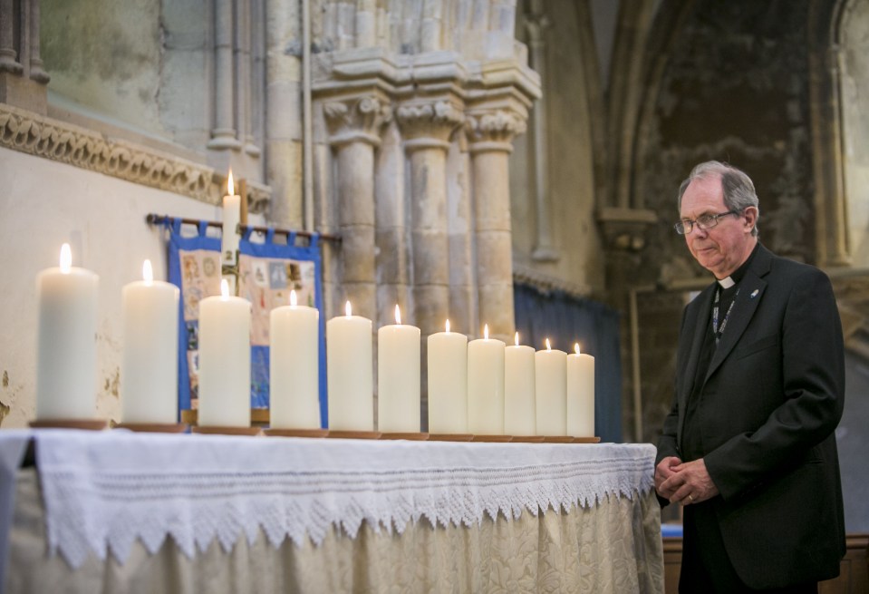  Eleven candles were lit by relatives during the service to remember the dead