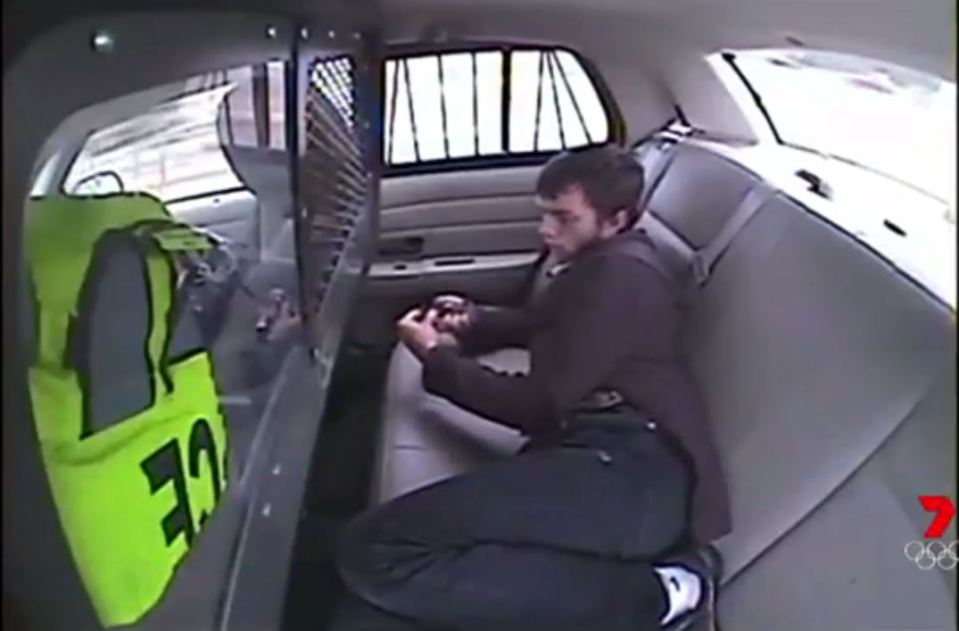  Suspect Logan Younger is seen in the back of a police car before the crash