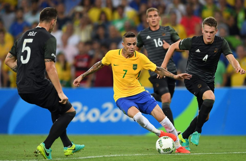 Luan holds off a challenge from Germany's Matthias Ginter in the Olympic final