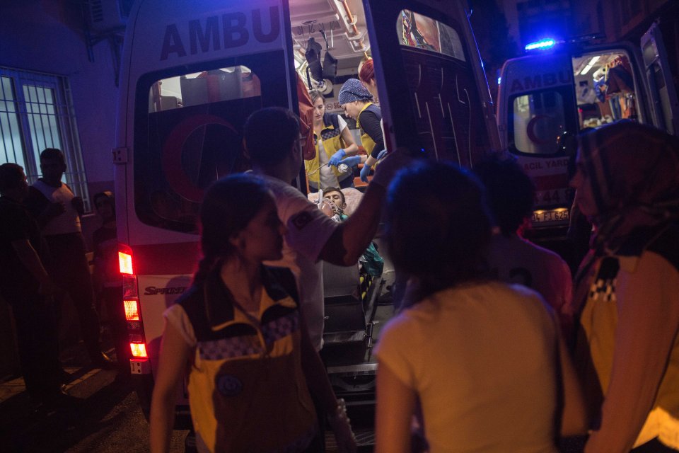  First aid officers carry the injured man into an ambulance