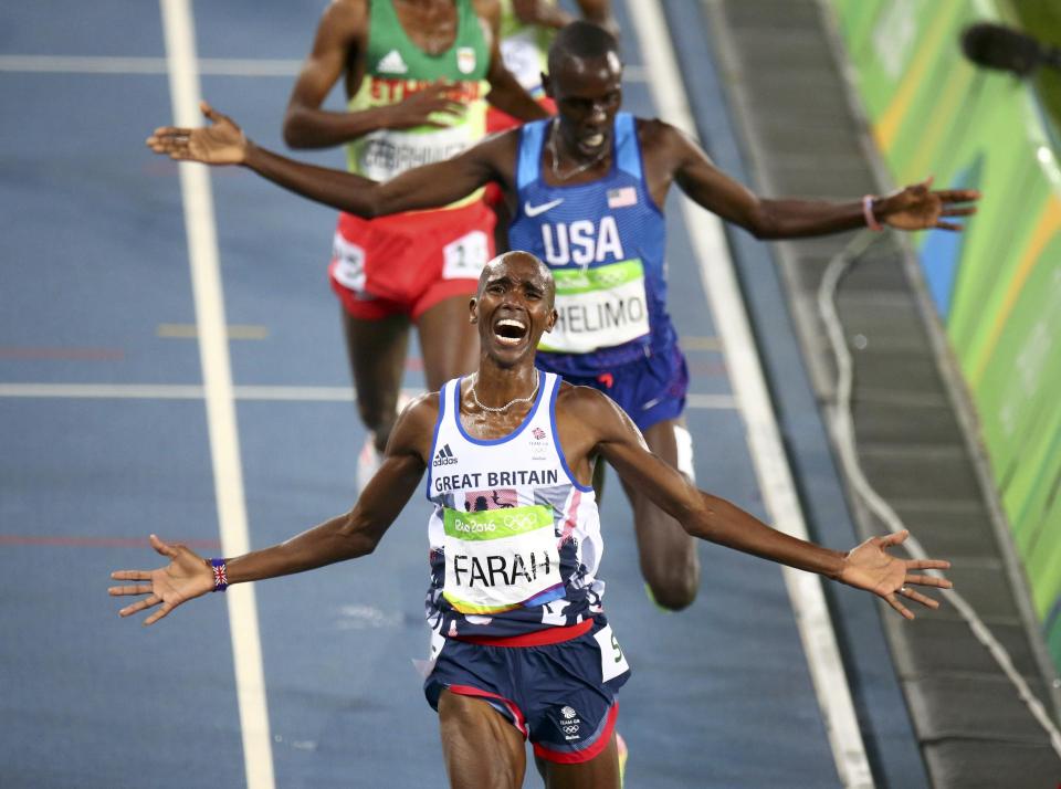 Mo Farah stretches out his arms as he celebrates a fourth Olympic title