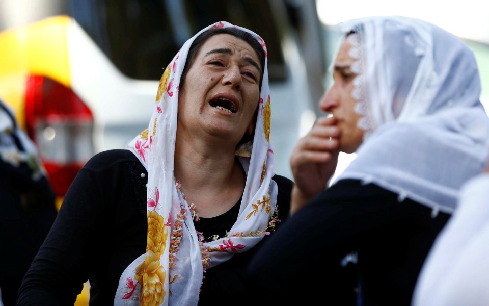  Women mourn as they wait in front of a hospital morgue in the Turkish city of Gaziantep