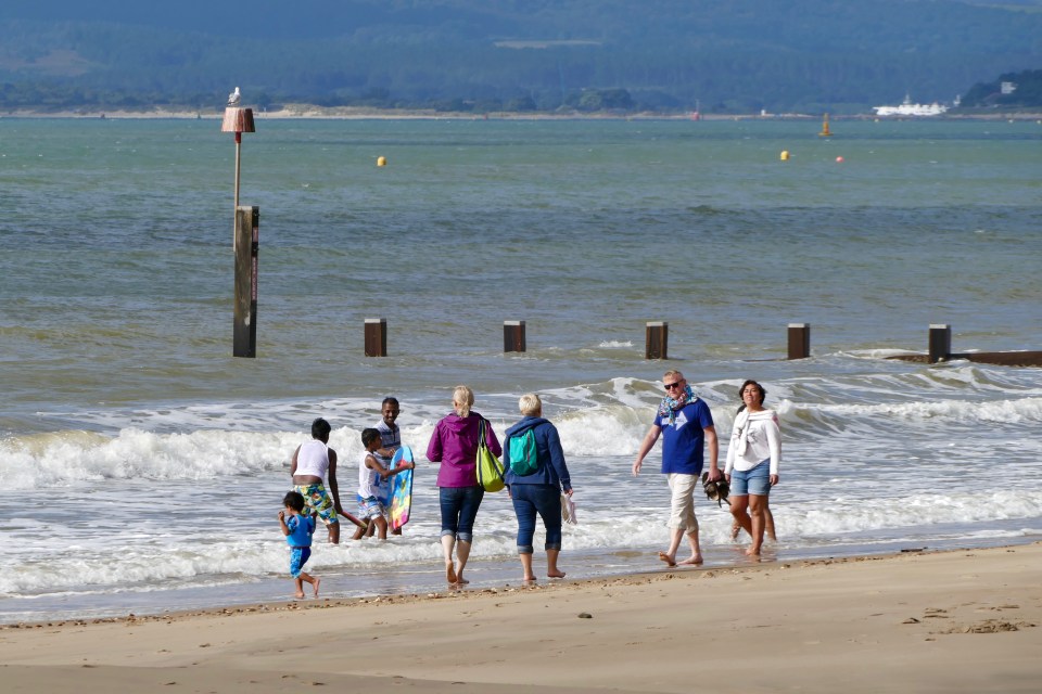  People enjoy a sunny morning on Bournemouth beach ahead of a mini-heatwave next week