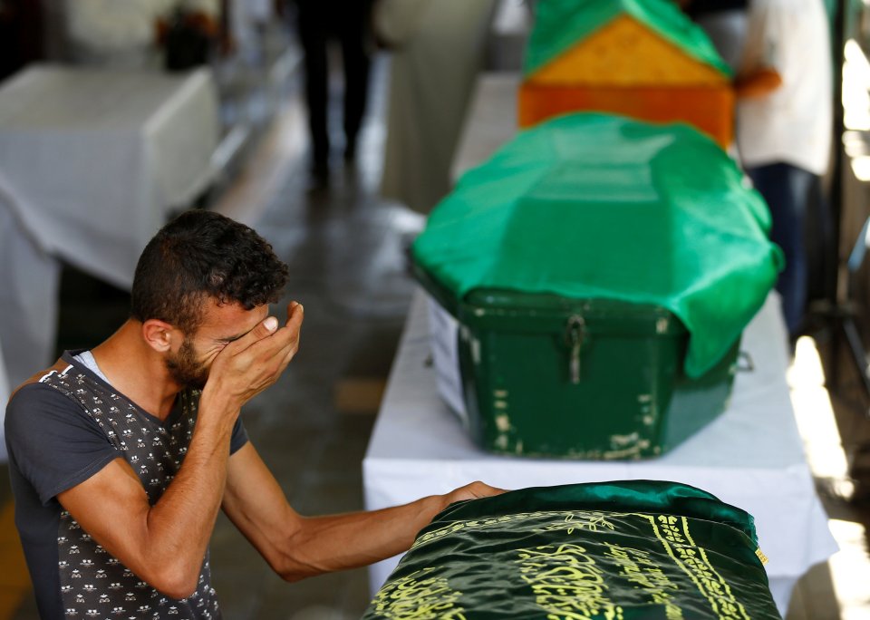  A man mourns at the coffin of a relative who was killed in the blast