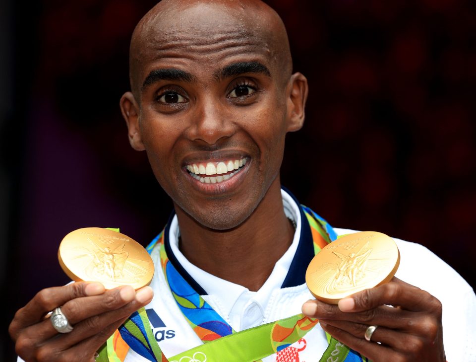 Farah with his gold medals for victory in the men's 5000m and 10000m