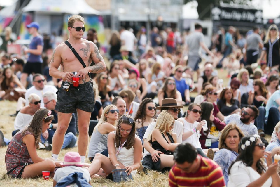  A reveller strips down at V Festival after temperatures shot up today following a miserable start to the festival