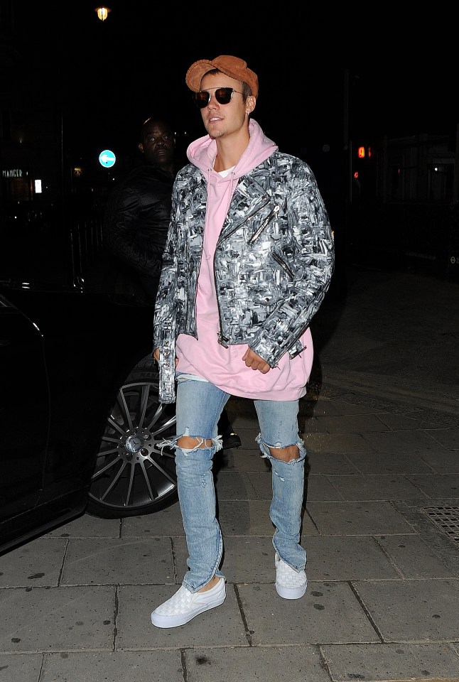 The singer showed off his cool side by wearing a camouflage jacket over his pink hoodie