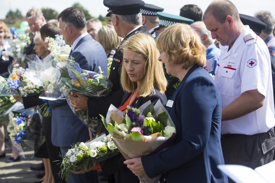  Victims families watched as flowers were laid, while emergency service officers and civic leaders joined the emotional tributes