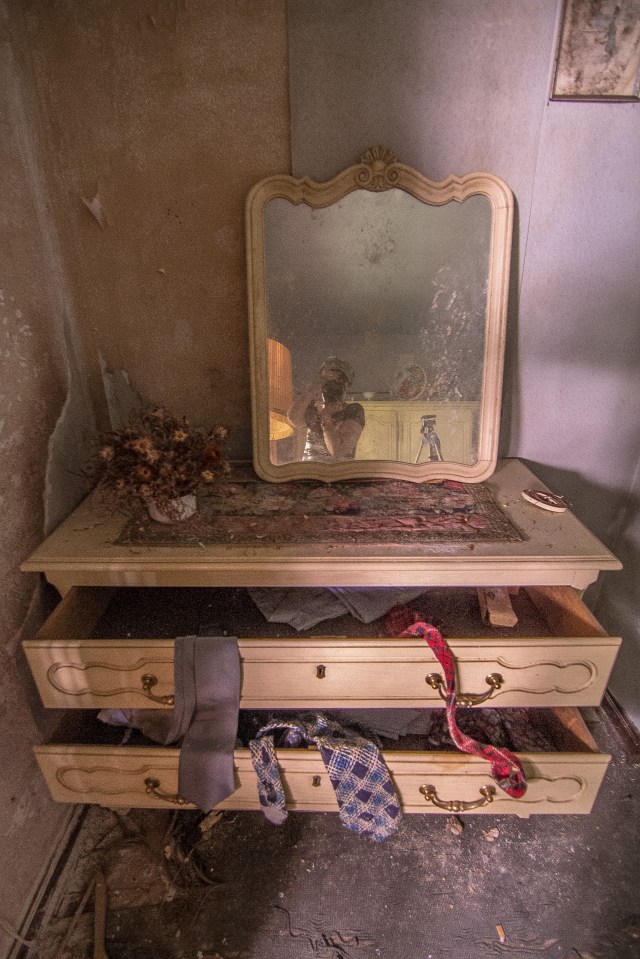 A mirror and the previous occupant's ties are still visible in one of the bedrooms