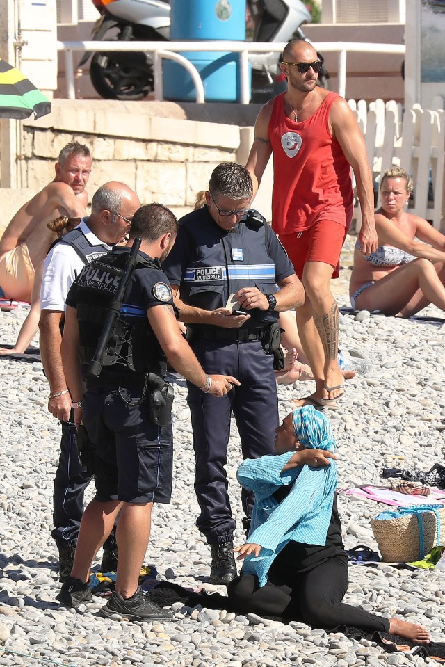 Enforced ... Photos have emerged showing a woman being questioned by cops over her attire, but some suggest it was a publicity stunt