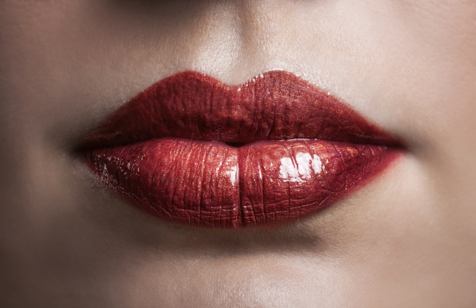 Close up of shiny metallic looking red lips