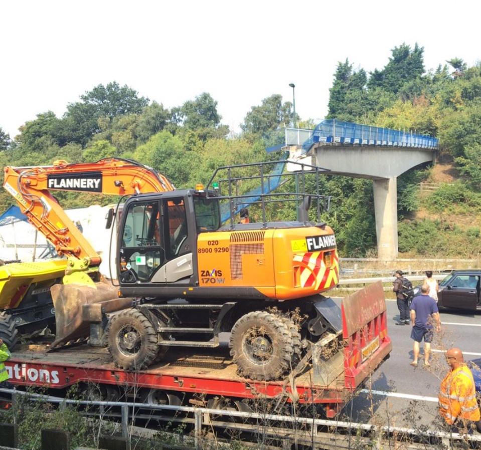  A lorry is trapped under the rubble as emergency services block the road off in both directions