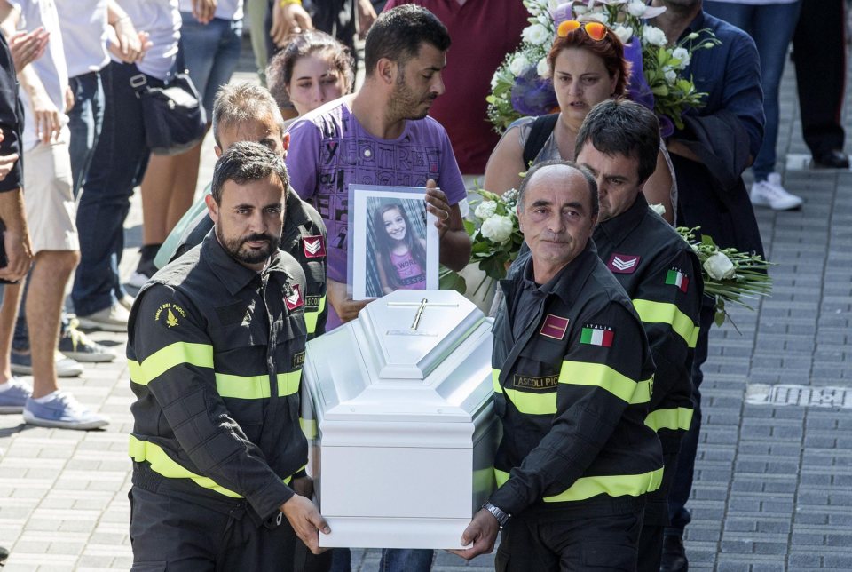  Rescue workers helped families carry their loved ones to the tragic ceremony near one of the worst-hit towns in central Italy