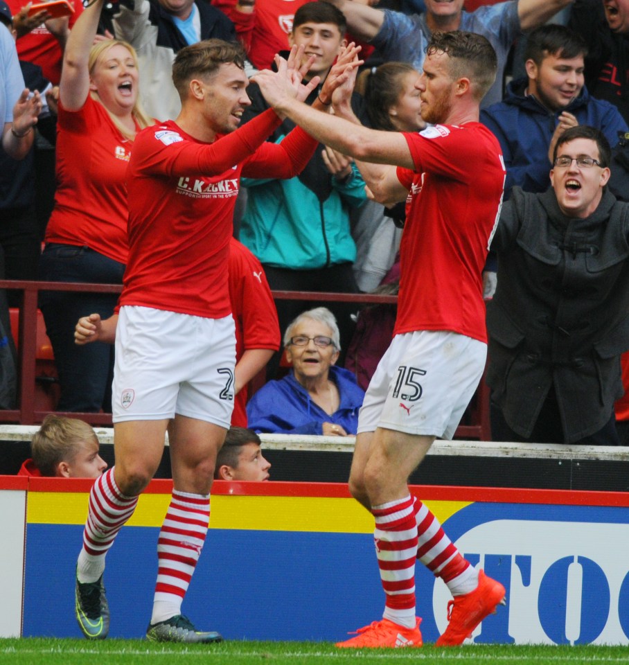  Barnsley's Tom Bradshaw and Marley Watkins celebrate the third goal.