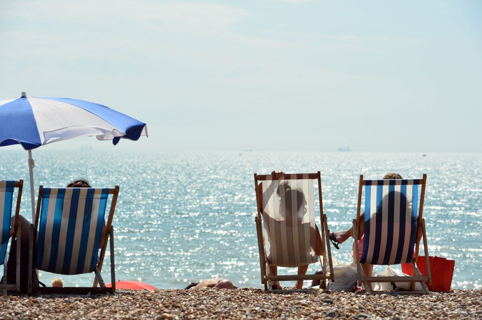  Beach-goers at Camber Sands catch a rare glimpse of sunshine over this weekend