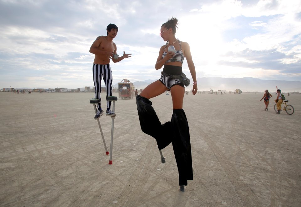  Walking tall ... Stilters "Divine Mustache" and "Katapult Sandra" do a tall dance in the desert