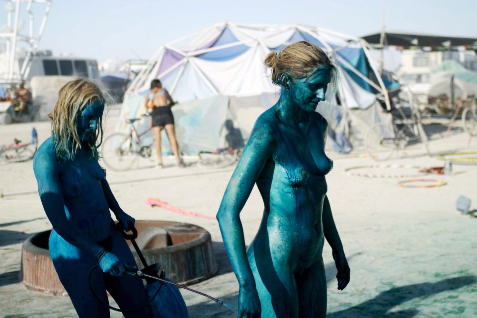  Feelin' blue ... Painted party-goers touch up their coating at Burning Man