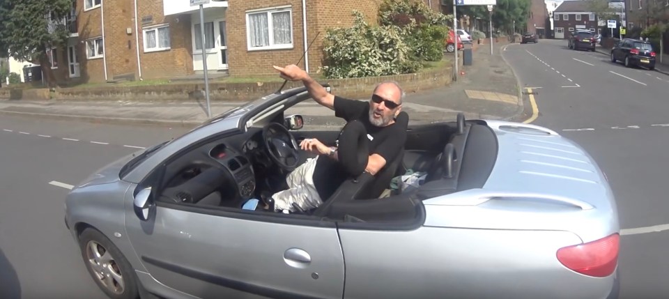 The balding driver then points accusingly at cyclist Dave Wiliams