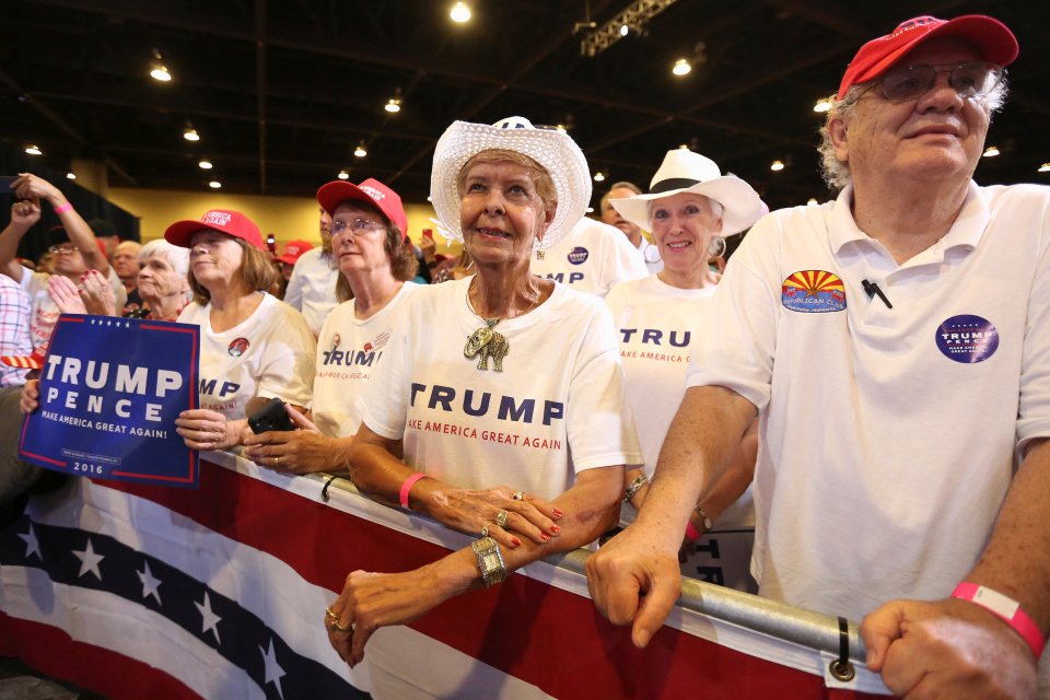 Supporters listen to Republican presidential nominee Donald Trump as he speaks at a campaign rally in Phoenix, Arizona, U.S.