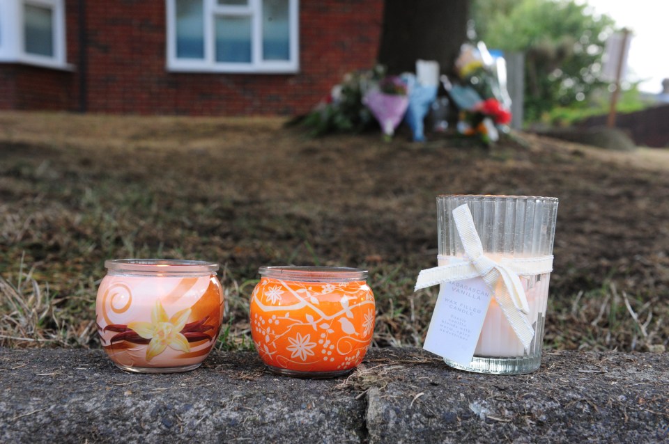 Candles line the pavement which was mounted by fleeing stolen car