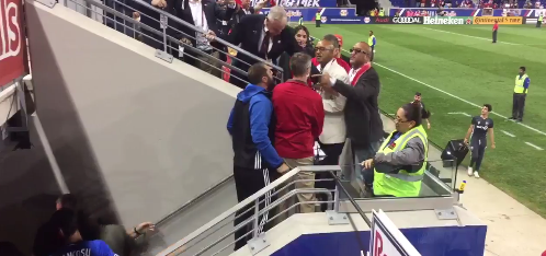  One fan continues the argument with Didier Drogba after the striker walks away