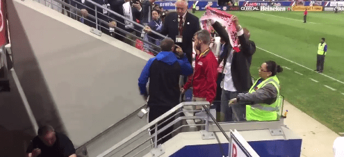  One New York Red Bulls fan proudly displays his team scarf after the altercation