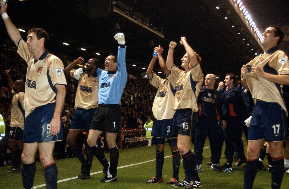 MANCHESTER, UNITED KINGDOM: Arsenal players (L-R:) Martin Keown, captain Patrick Vieira,keeper David Seaman, Ashley Cole,Ray Parlour, and Edu celebrate after a premier league match win over Manchester United at Old Trafford 08 May 2002. The win secured Arsenal the double after winning the cup final 04 May 2002. (Photo credit should read PAUL BARKER/AFP/Getty Images)