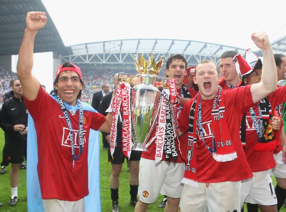 WIGAN, ENGLAND - MAY 11: Carlos Tevez and Wayne Rooney of Manchester United celebrates with the Premier League trophy on the pitch after the Barclays FA Premier League match between Wigan Athletic and Manchester United at JJB Stadium on May 11 2008, in Wigan, England. (Photo by John Peters/Manchester United via Getty Images)