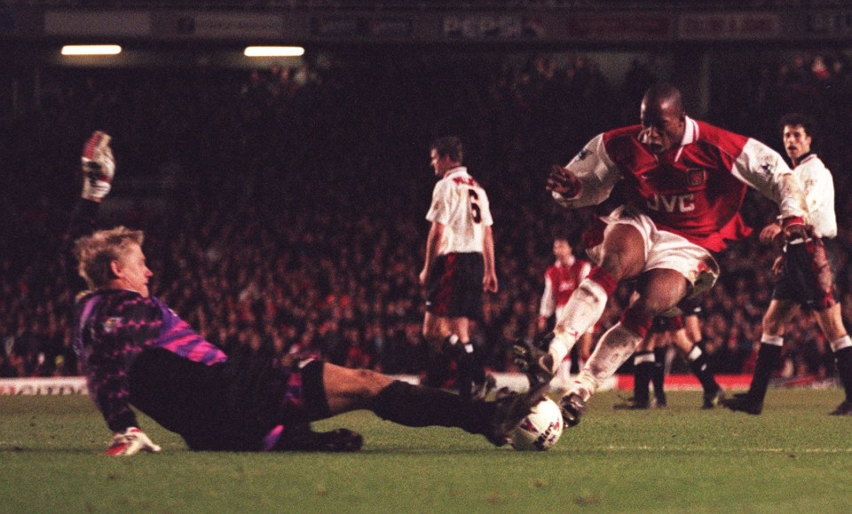 ARSENAL V MANCHESTER UNITED 19.2.97. IAN WRIGHT TACKLING PETER SCHMEICHEL AFTER THE REFEREE HAD CALLED OFF SIDE.