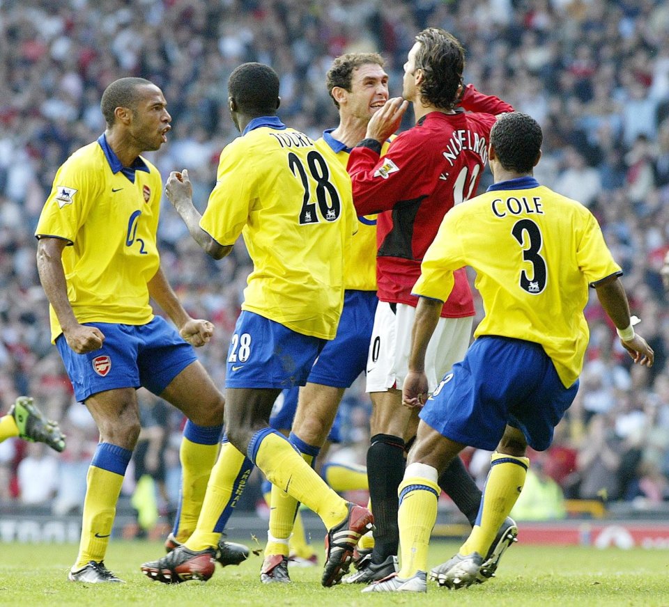 Arsenal's Martin Keown (third right) mocks Manchester United's Ruud Van Nistelrooy (second right) after his penalty miss, at the end of the FA Barclaycard Premiership match at Old Trafford, Manchester Sunday September 21 2003. Manchester United drew 0-0 with Arsenal. PA Photo: Martin Rickett. THIS PICTURE CAN ONLY BE USED WITHIN THE CONTEXT OF AN EDITORIAL FEATURE. NO WEBSITE/INTERNET USE UNLESS SITE IS REGISTERED WITH FOOTBALL ASSOCIATION PREMIER LEAGUE.