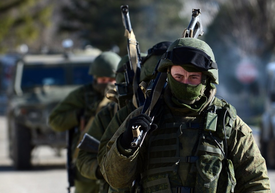  Russian soldiers bearing no identifying insignia march through a Ukrainian naval base during their annexation of the region in 2014