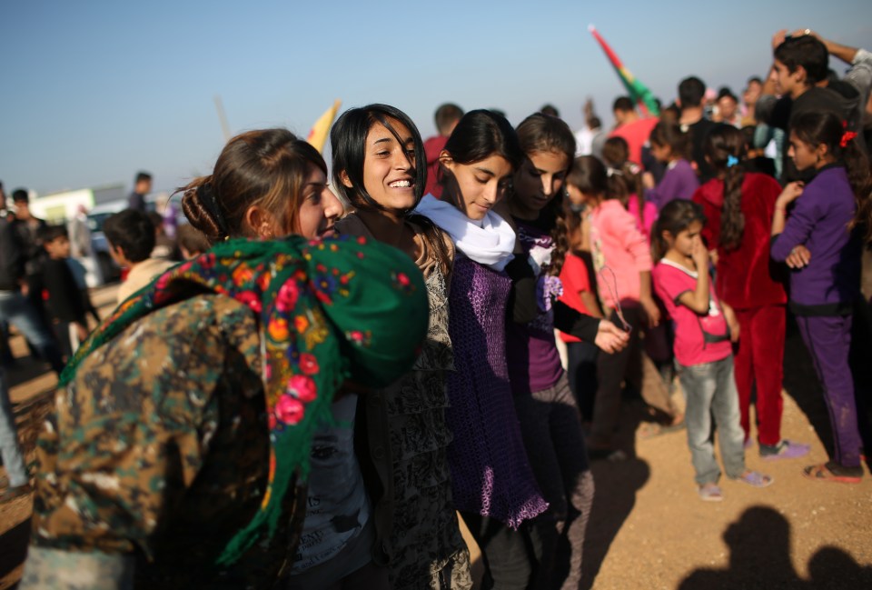  Yazidi refugees celebrate news of the liberation of the'r homeland of Sinjar