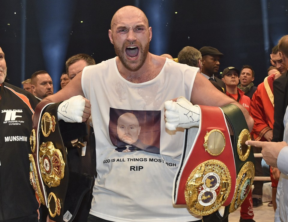 Tyson Fury, celebrates with the WBA, IBF, WBO and IBO belts after winning the world heavyweight title fight last year