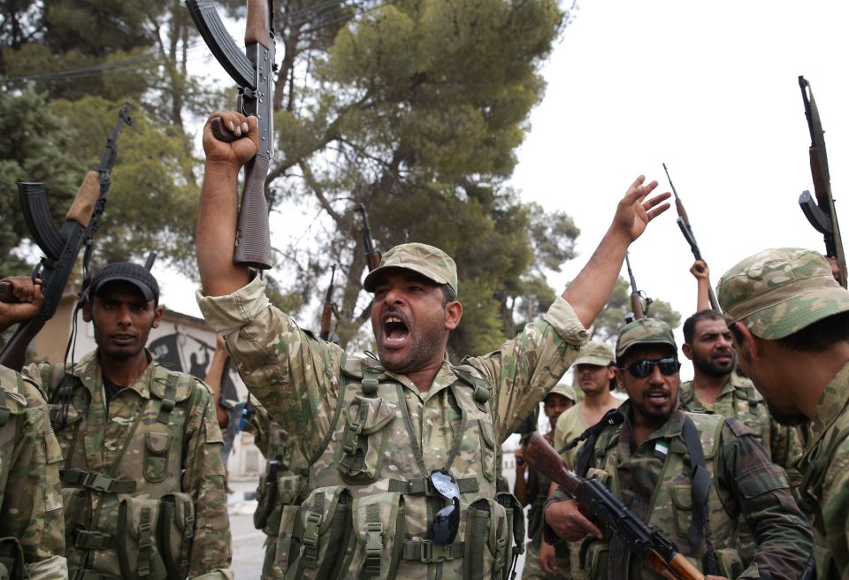  Members of Free Syrian Army celebrate in Jarabulus after taking control of the Syrian district