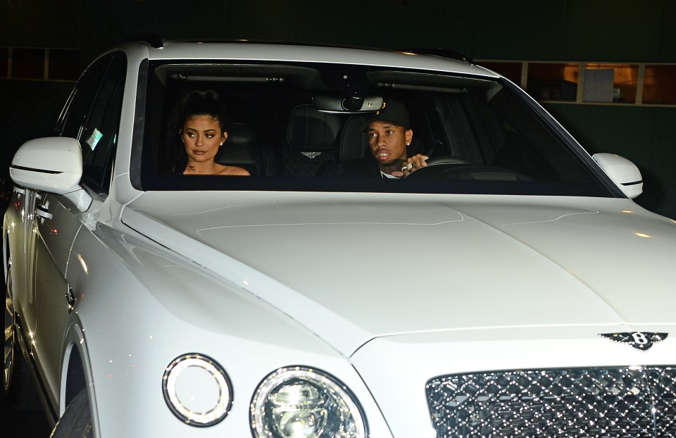  Tyga gets to grips with his new £230,000 toy as he drives Kylie from the event